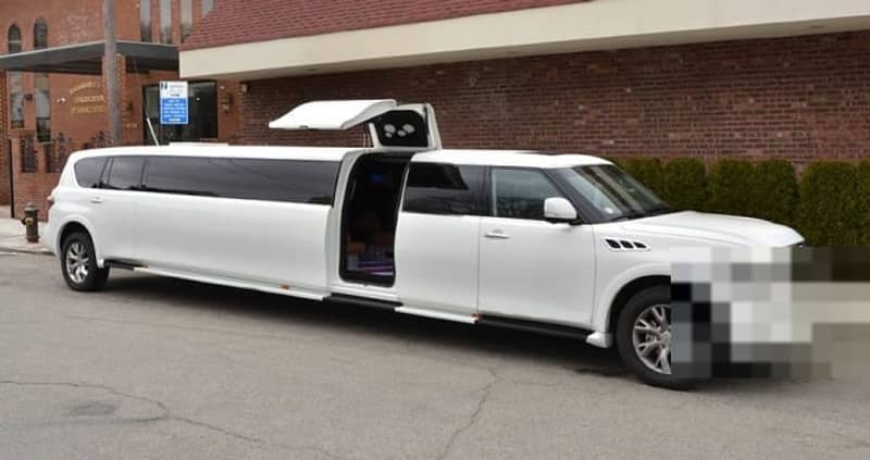 Infiniti QX80 Stretch — white Infiniti QX80 stretch SUV limousine