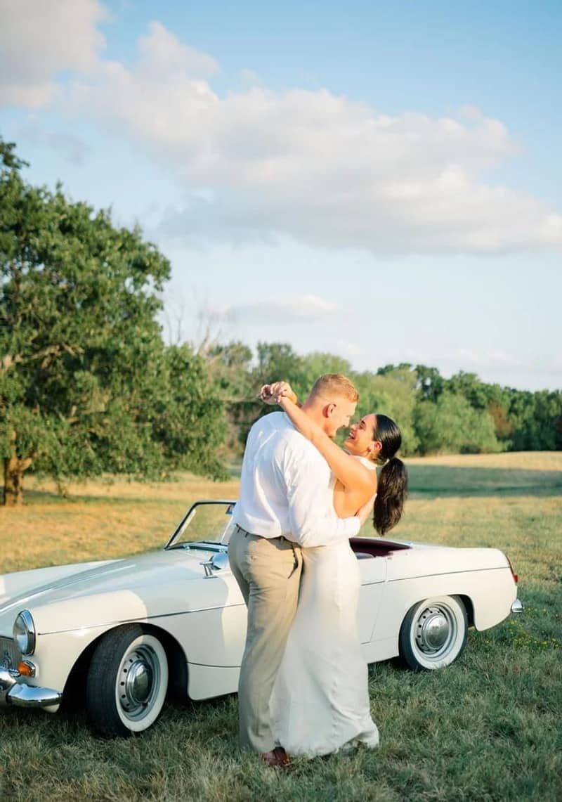 1960s Classic Roadster — white 1960s classic roadster convertible with couple at engagement shoot